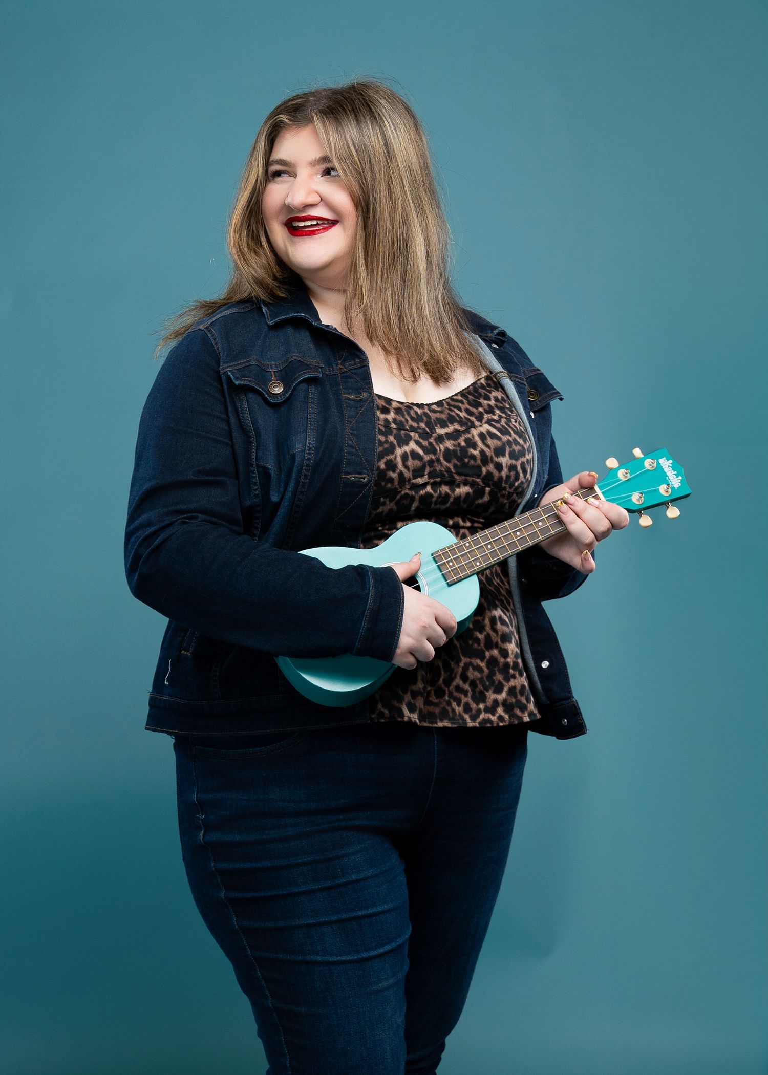 A series of photos showing someone in dark denim playing a teal ukulele against a blue-green backdrop.