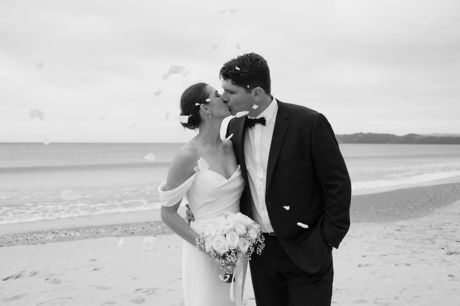 A collage of beach wedding photos showing newlyweds walking along sandy shores with turquoise ocean views.