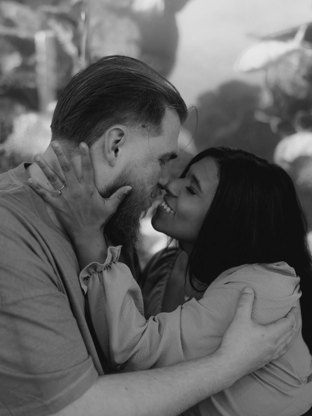 A romantic black and white photo sequence shows a couple sharing tender moments and kisses.