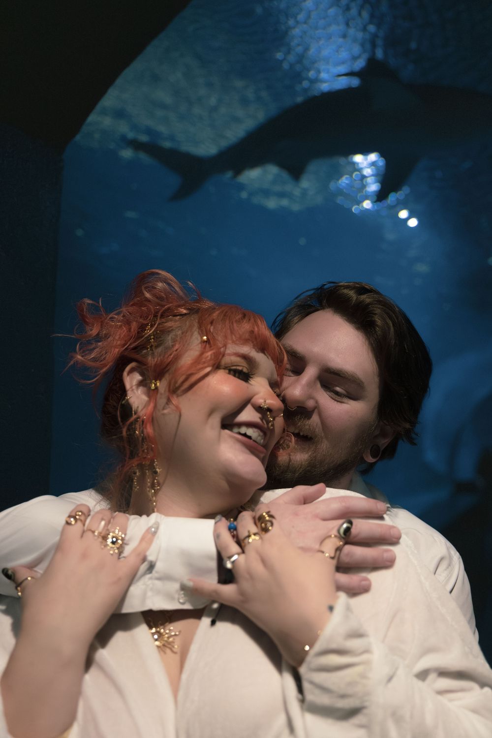A romantic sequence of photos with a couple in white clothing against a dark blue background.