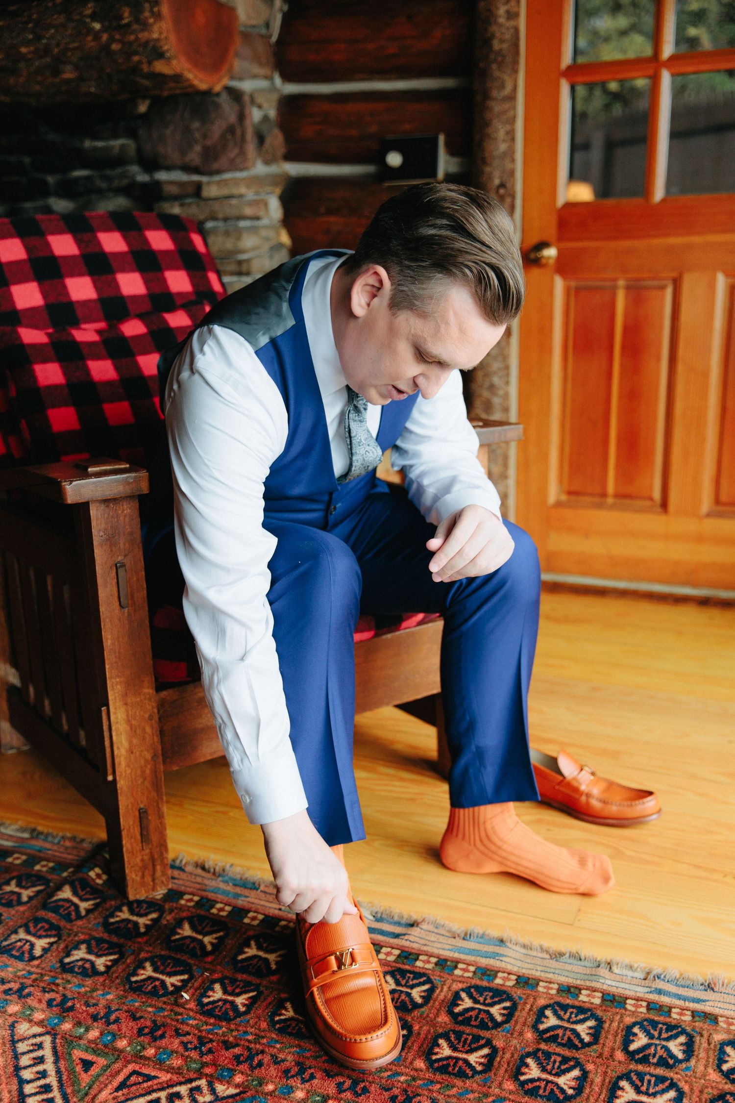 Wedding day preparation showing brown leather dress shoes and blue suit details.