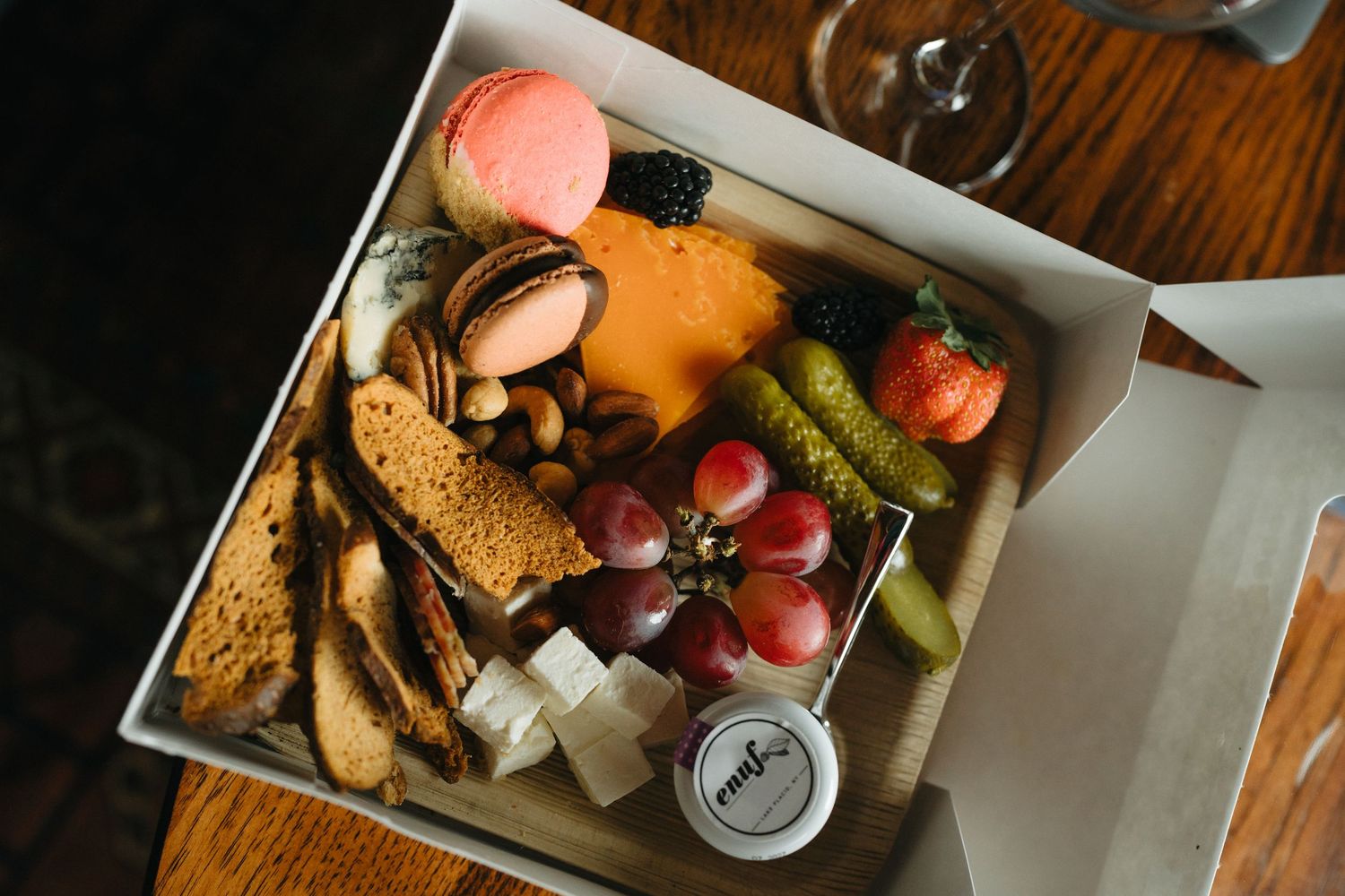 Overhead view of various sandwiches and snacks arranged on white plates.