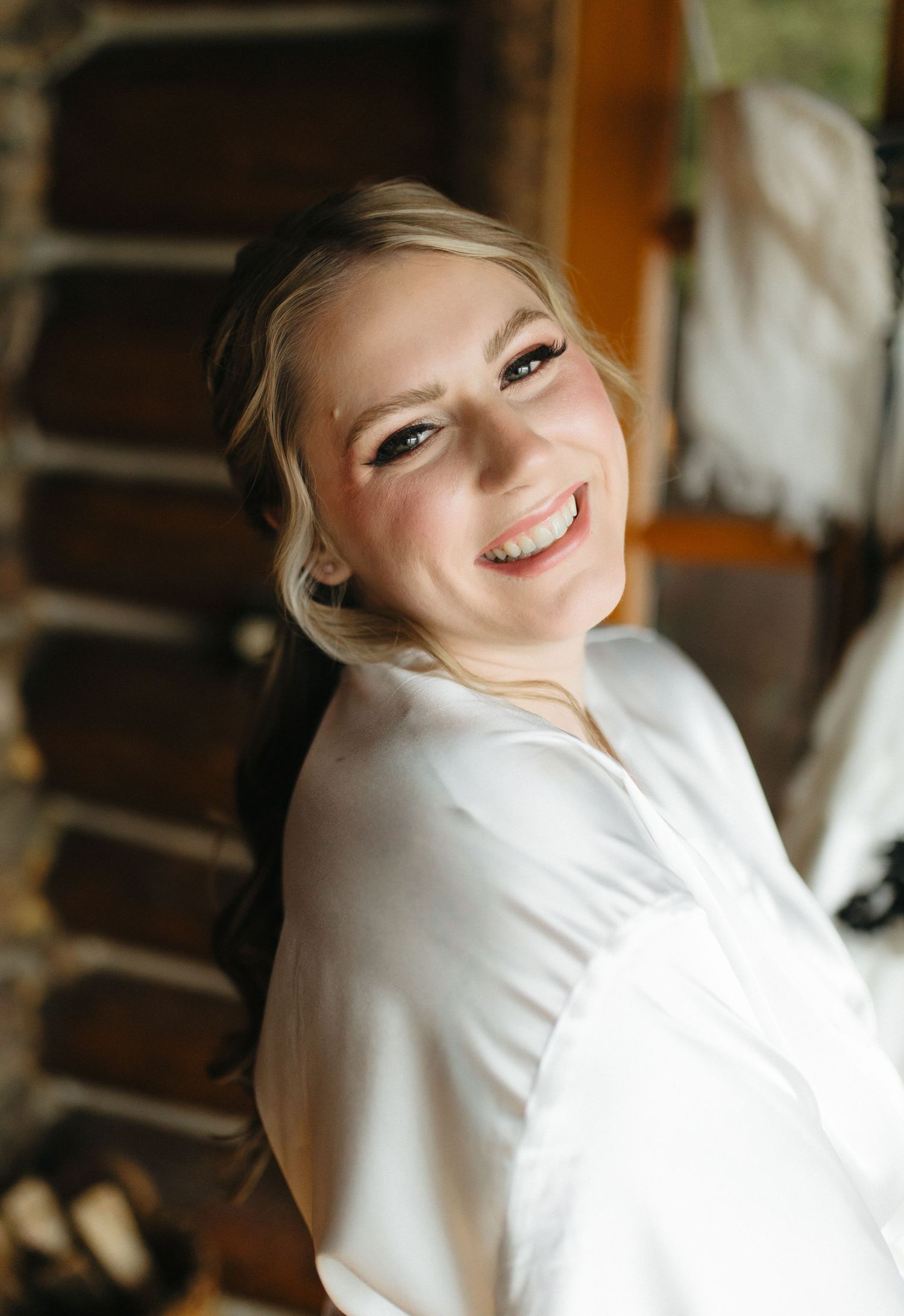Series of joyful portraits in white clothing against a warm interior setting with natural window light.