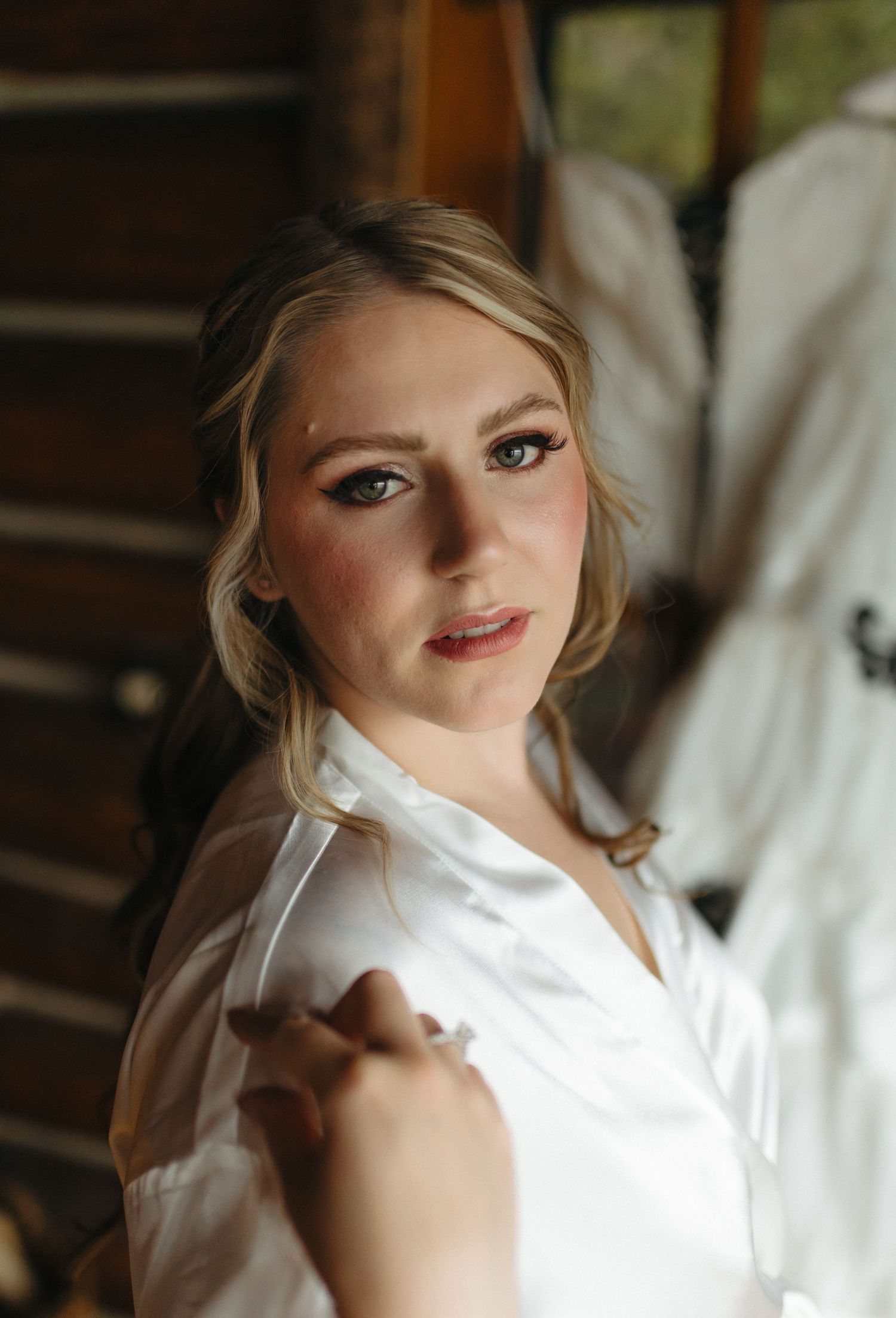 Getting ready wedding photo in a rustic cabin setting.