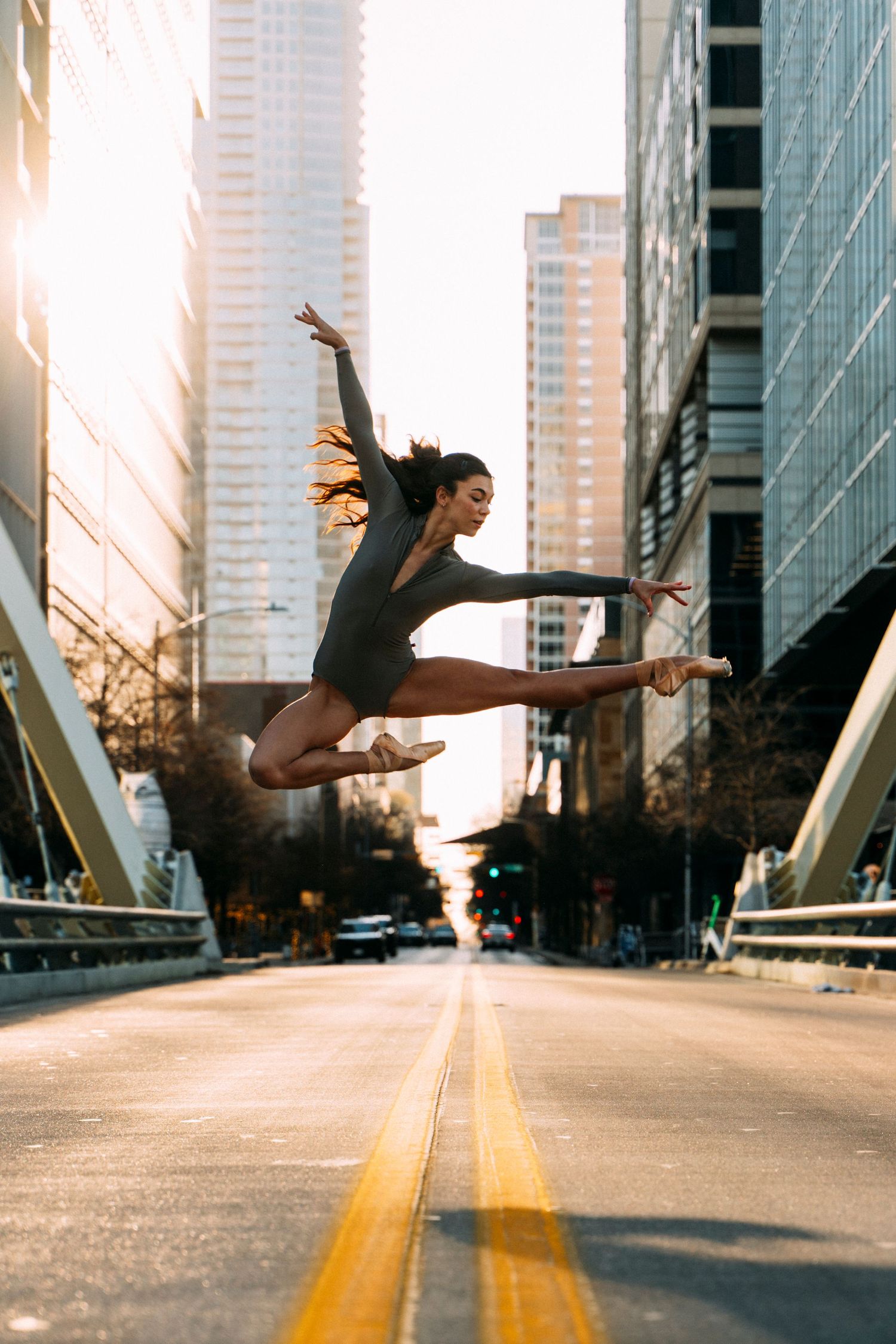 Ballet Austin company dancer captured mid-leap in downtown Austin during a sunrise dance photography session