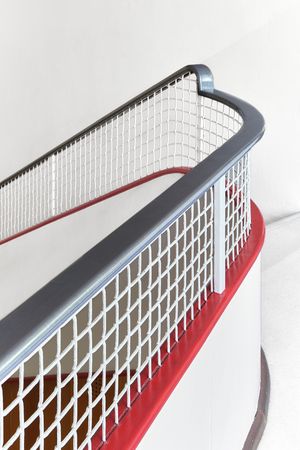 Close-up sequence of a modern skyscraper facade with geometric pattern of white and silver lines against red background.