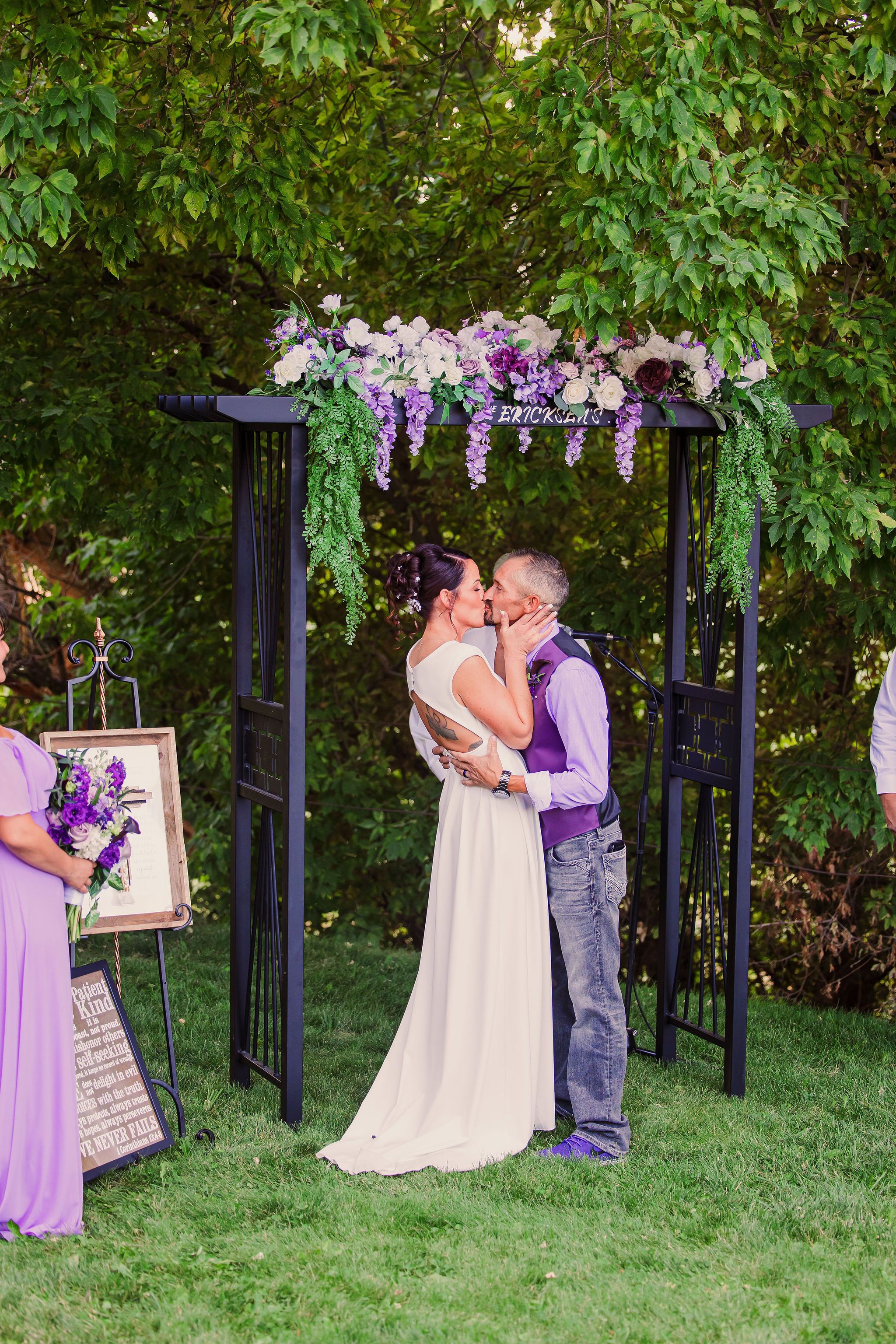 Romantic outdoor wedding ceremony sequence with purple floral arch decorations and greenery in garden setting.