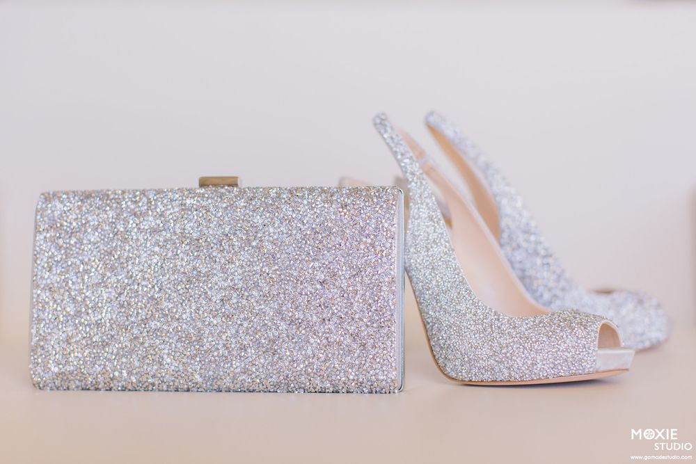 Close-up details of glittering silver bridal shoes with crystal embellishments.