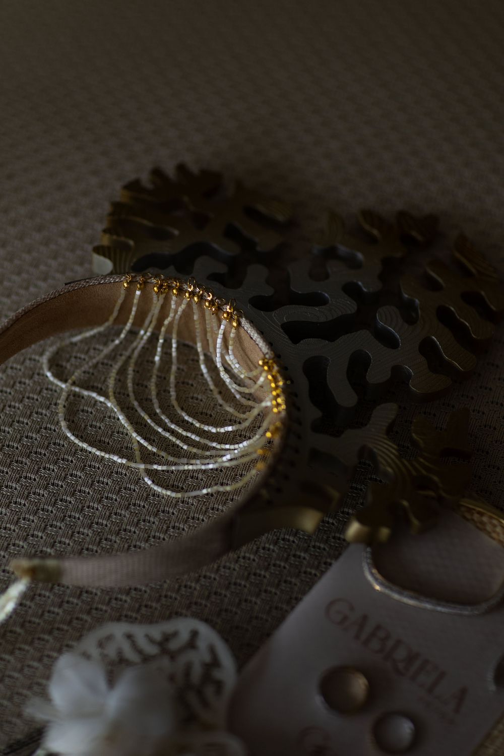 A macro photo sequence showing a water droplet falling and creating ripple patterns on a textured metallic surface.