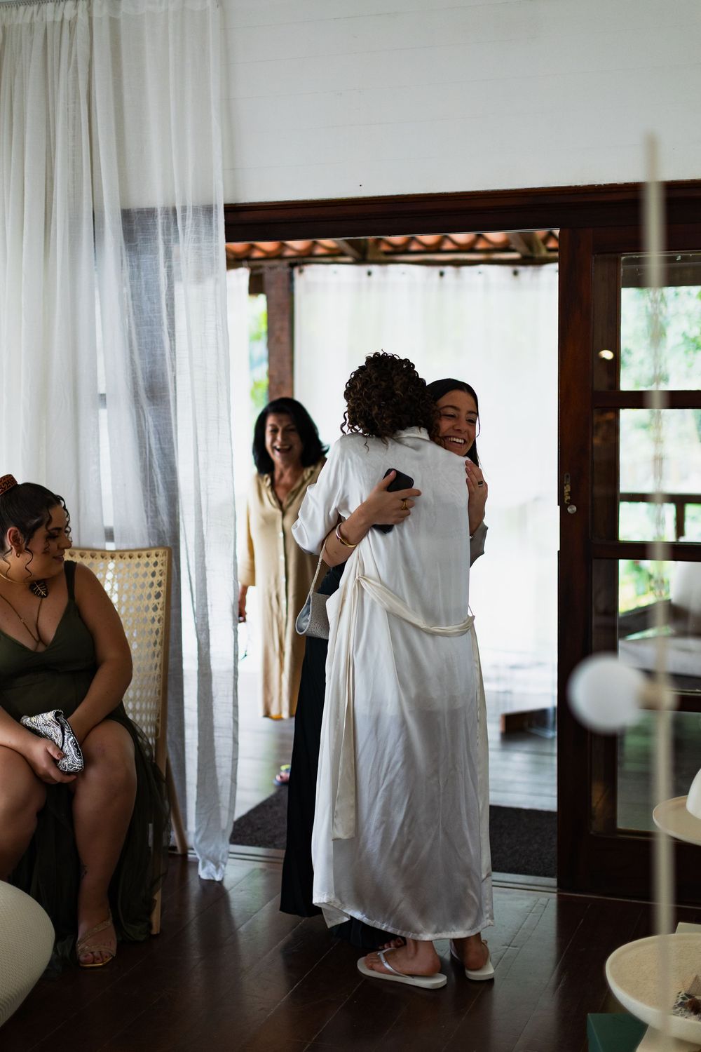 A series of artistic black and white photographs showing intimate moments through sheer curtains in an interior space.