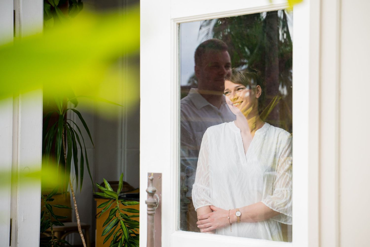 A series of minimalist lifestyle photos showing white robes and tropical plants against light walls in a spa-like setting. Shot by Luminair