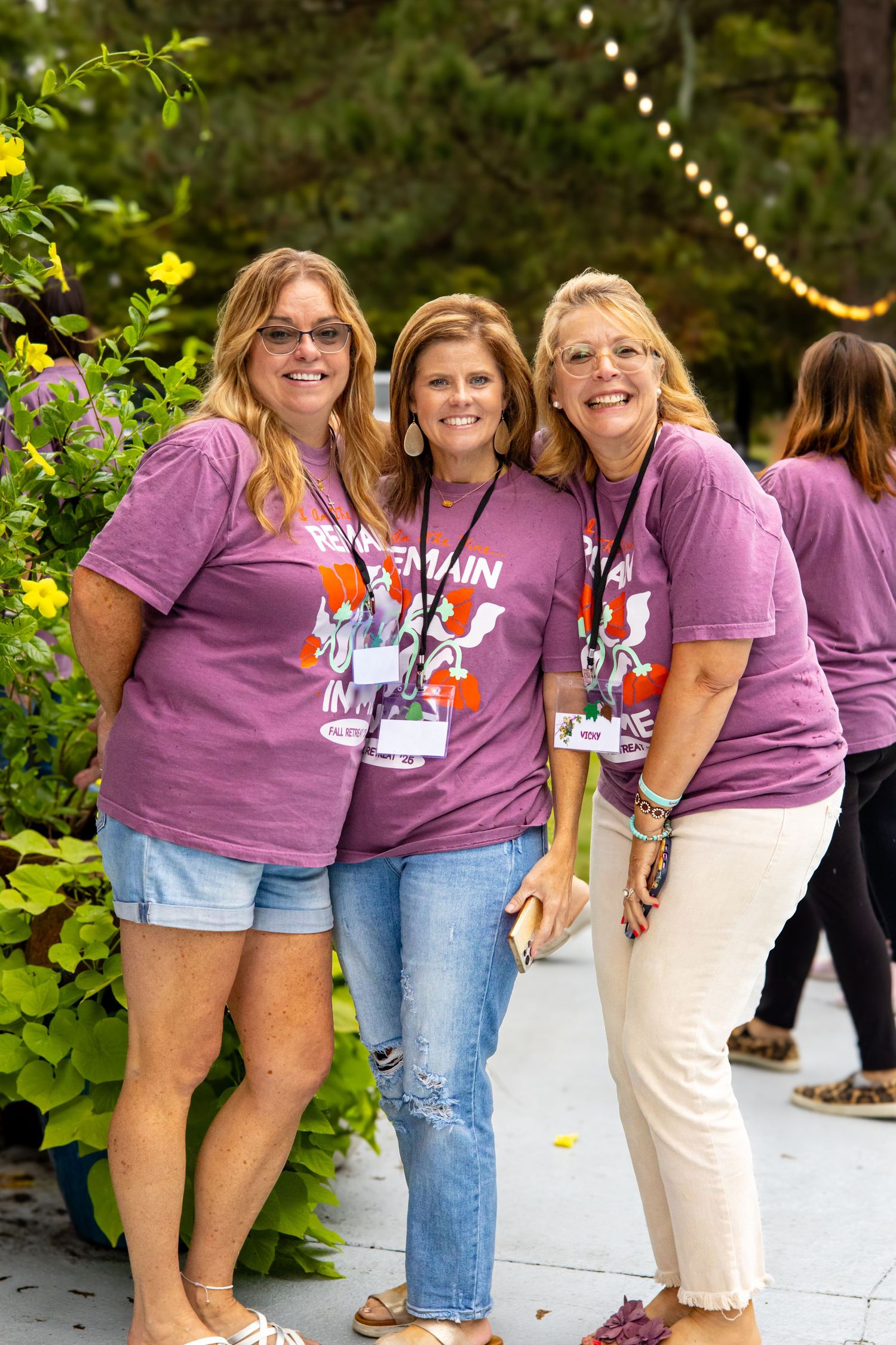 three women smiling at an event
