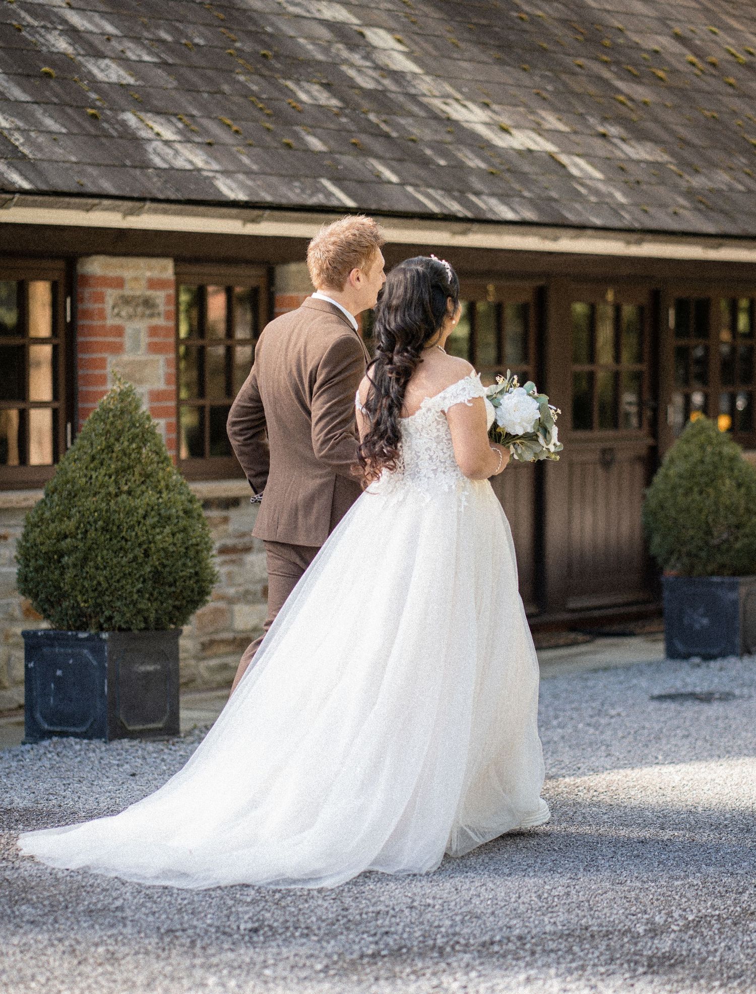 A sequence of wedding photos showing a couple in an intimate dip pose against a stone building exterior.