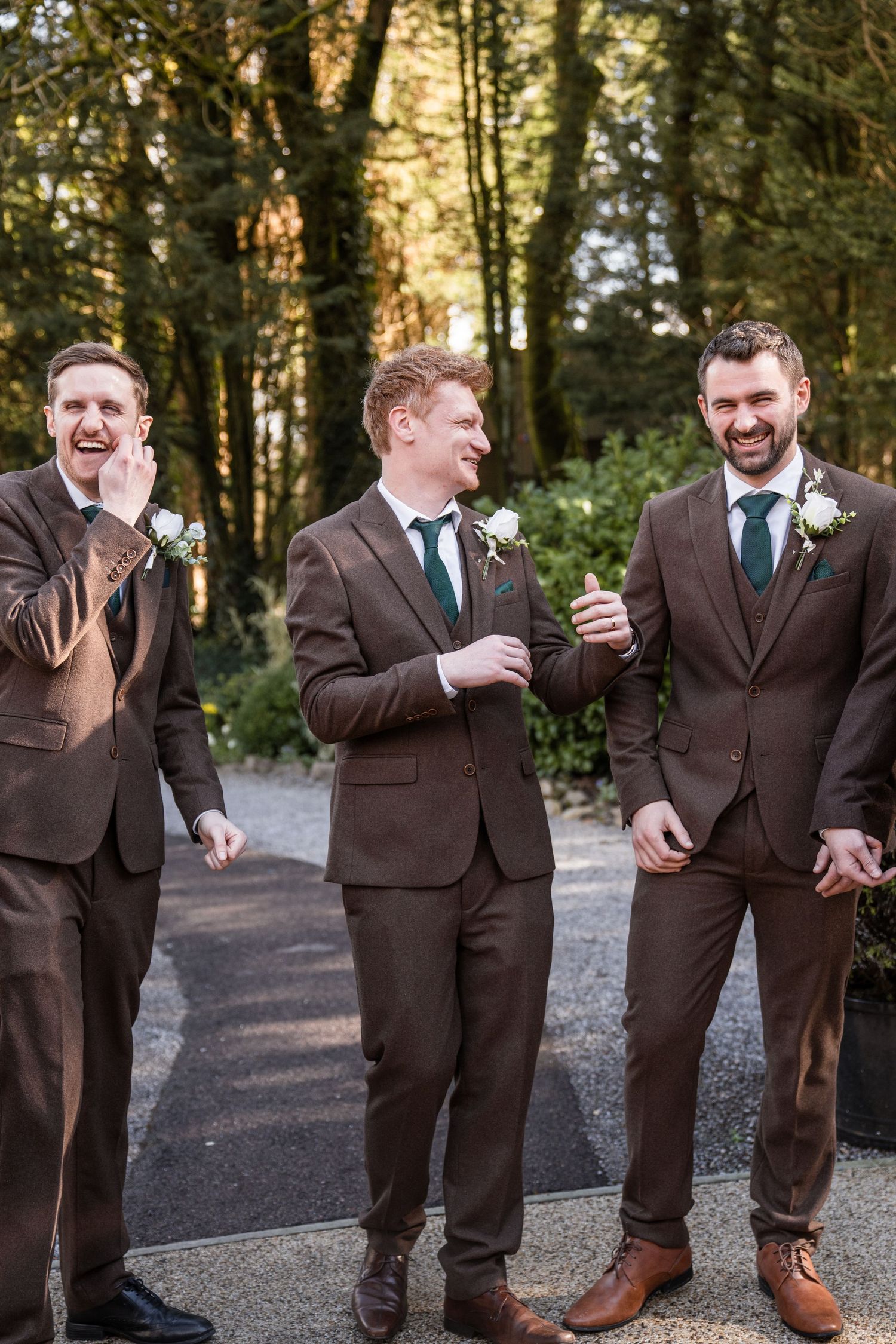 A sequence of candid photos showing groomsmen in brown suits laughing together on a wooded path.