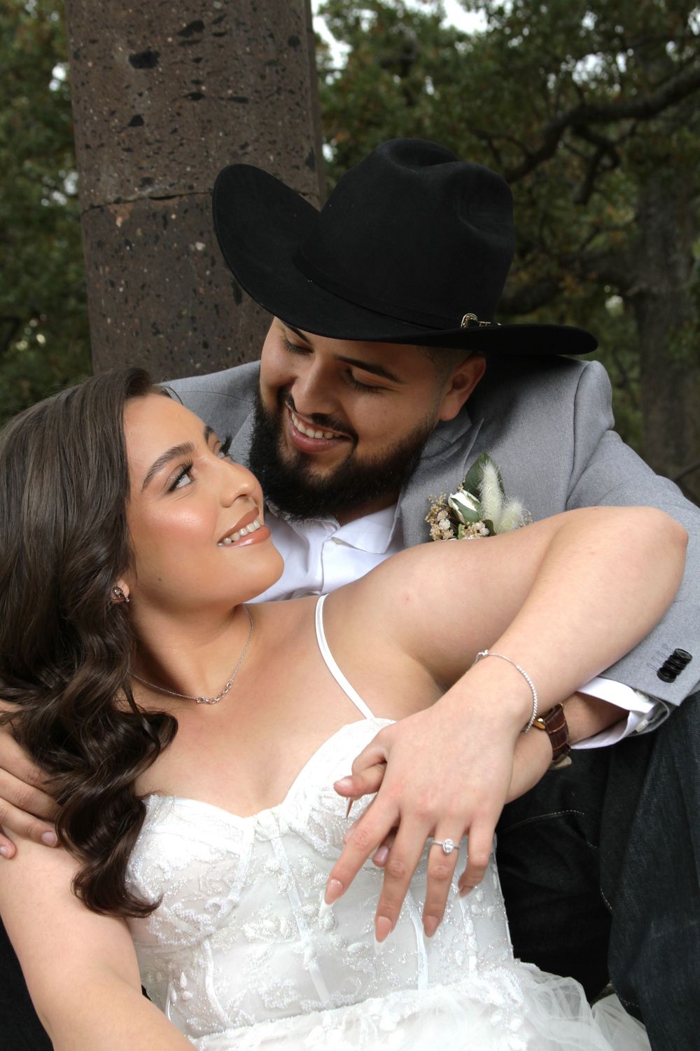 Intimate wedding portraits captured under trees with romantic natural lighting.