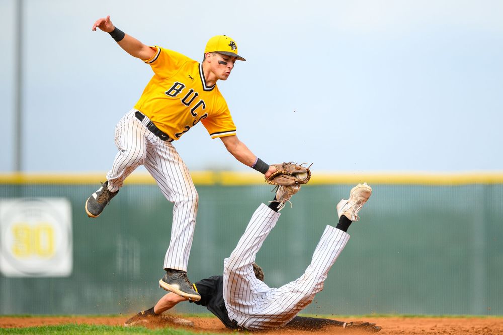 Georgetown, Texas - Southwestern University. Makes leaping catch over a sliding opponent at second base.