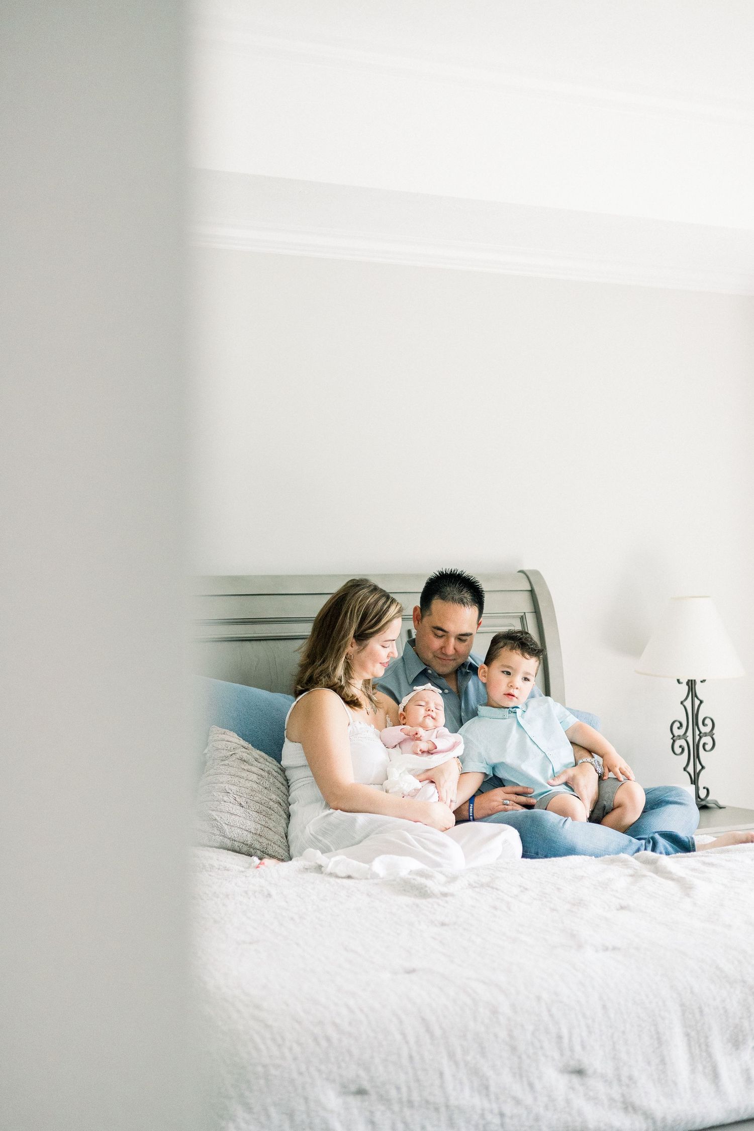 In-home newborn photography session in Augusta GA featuring sleeping baby swaddled in neutral tones