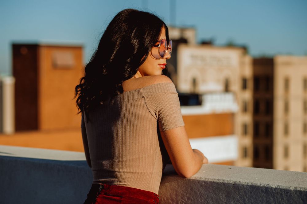 Sunset urban rooftop photography session with warm golden hour lighting.