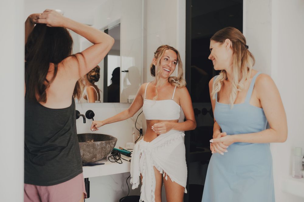 Applying makeup with a brush in front of a mirror.
