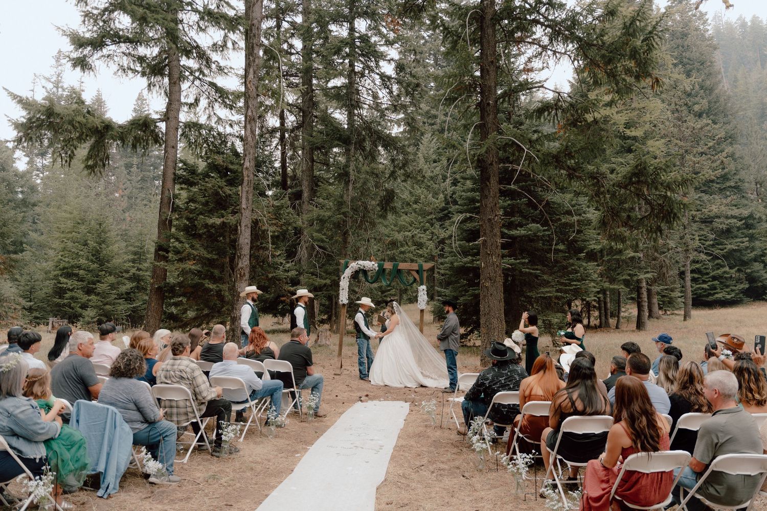 Bride and groom exchanging vows in front of guests during outdoor wedding ceremony at West Richland venue