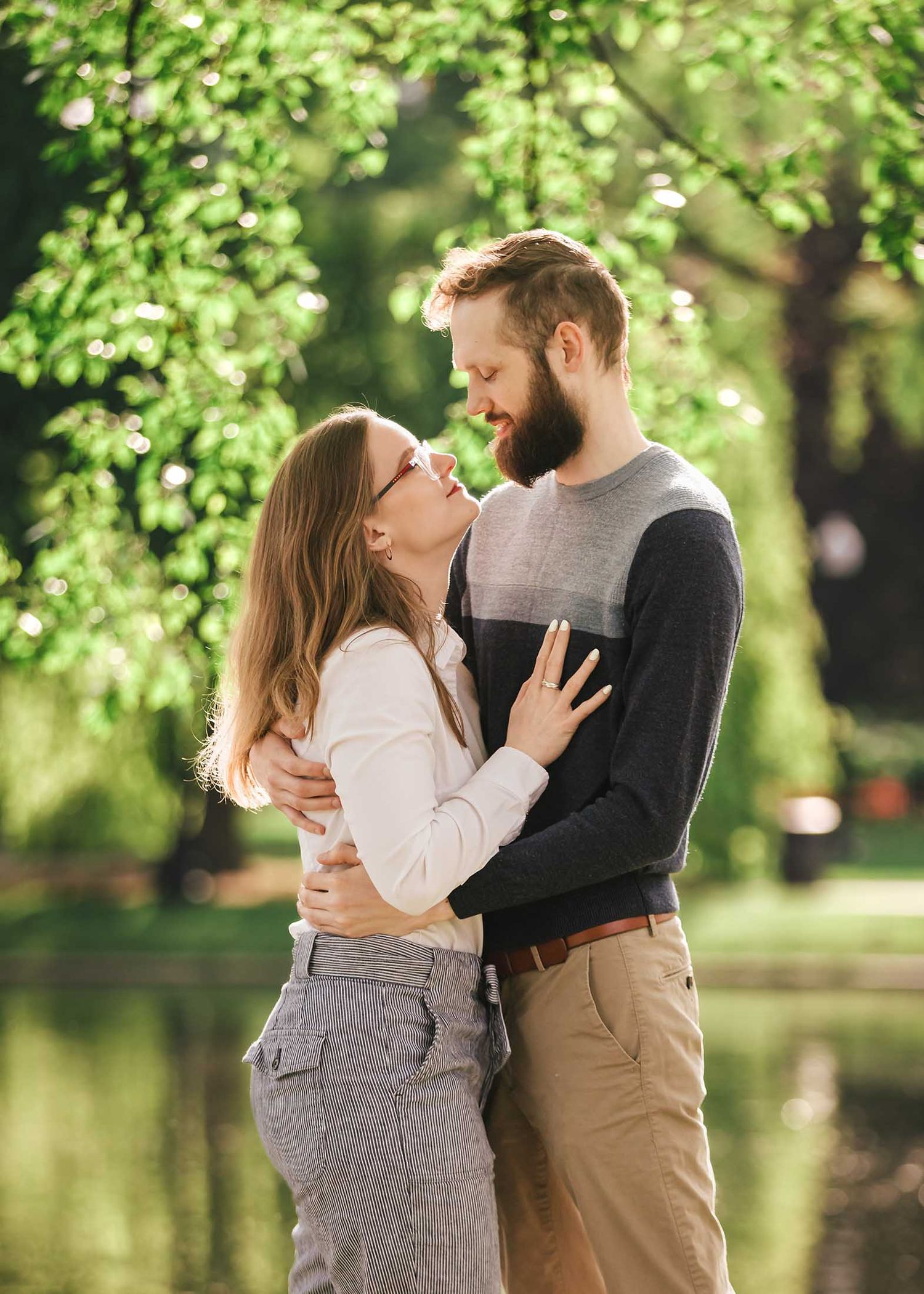 Romantic portrait of couple gazing into each other's eyes with beautiful morning light and Lagoon reflections in Boston Public Garden