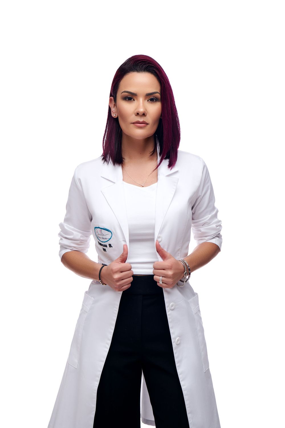 Medical professional in white lab coat and black dress makes three different expressive poses in composite image.