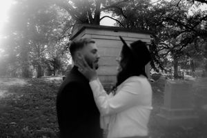 A tender black and white moment between a couple in an outdoor setting.