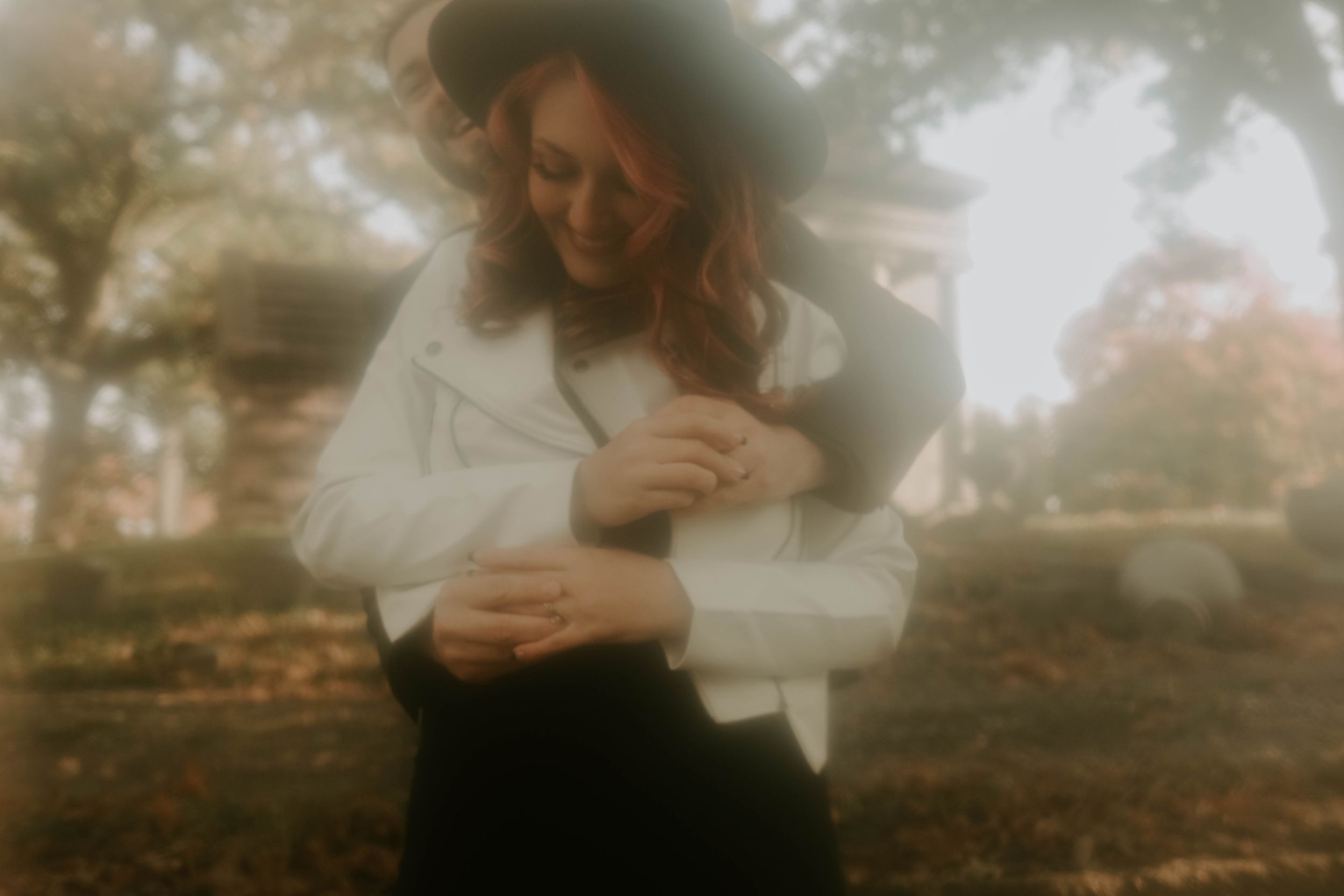 Soft focus romantic portraits capturing intimate moments in a misty outdoor setting.