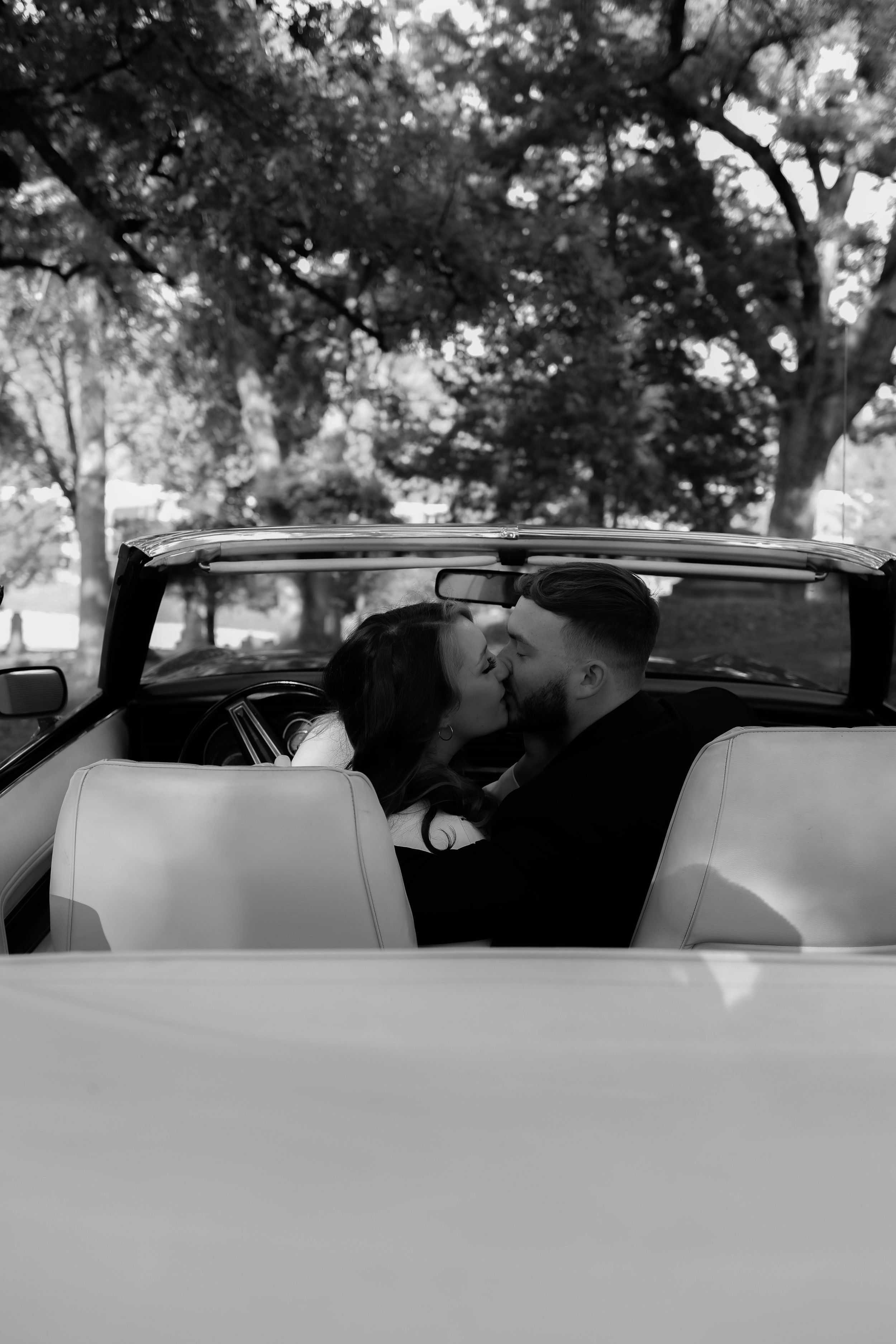 Black and white series of intimate moments captured in a vintage car.