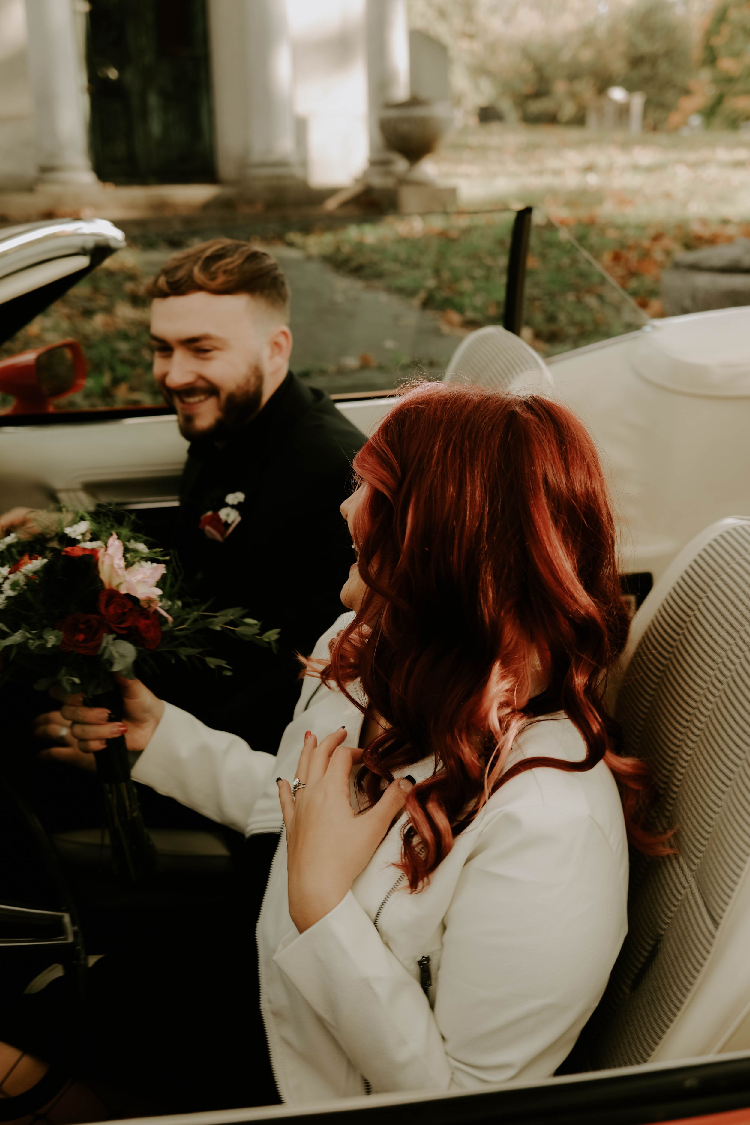 Candid moments of laughter and joy captured in a classic car photoshoot.