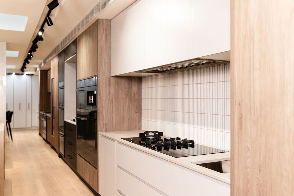 Contemporary office hallway with light wood paneling and track lighting.
