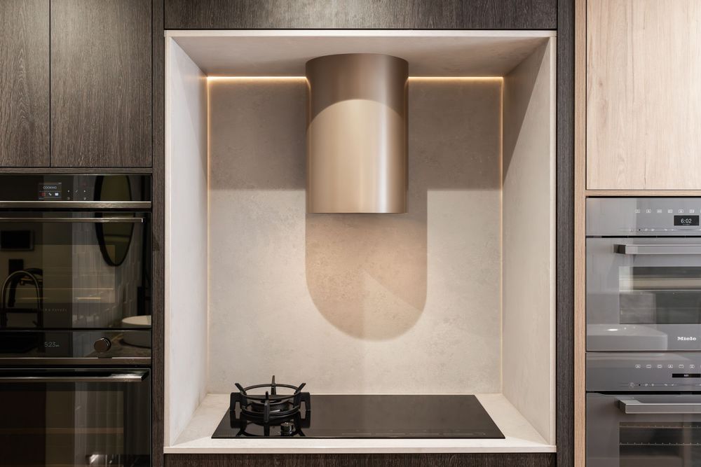 Contemporary white kitchen interior with minimalist design and built-in lighting features.