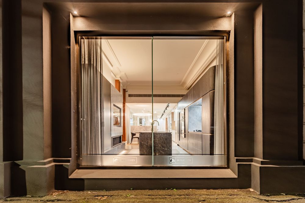 Long hallway with framed mirrors creating an elegant perspective in modern interior design.