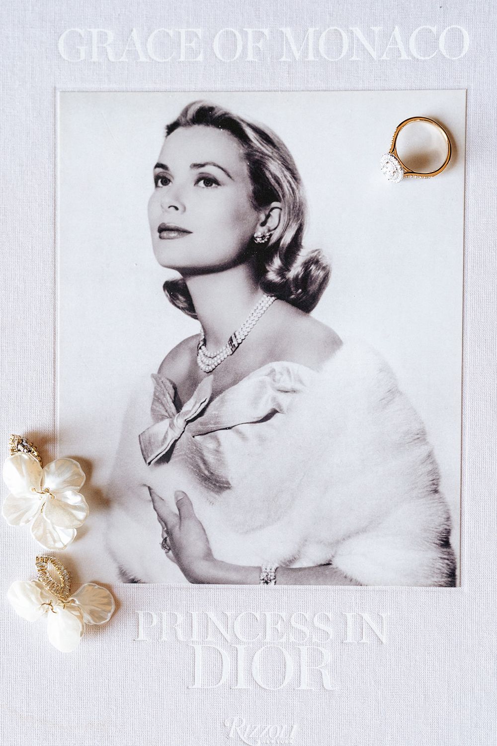 Black and white vintage fashion portrait with Dior branding and decorative shell embellishments on a white background.