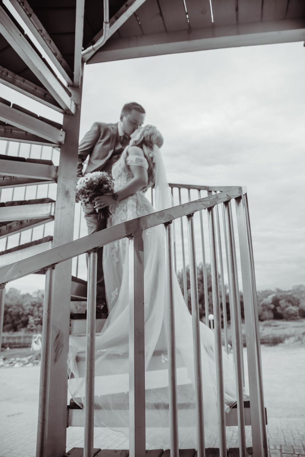 Three sequential images show a person in white climbing over white deck railing in an outdoor setting.