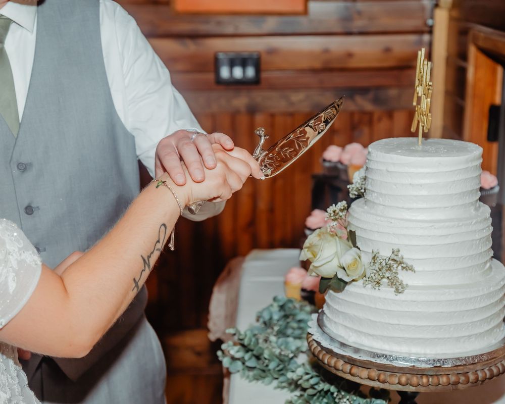 Wedding cake cutting sequence showing hands serving white tiered cake with floral decorations.