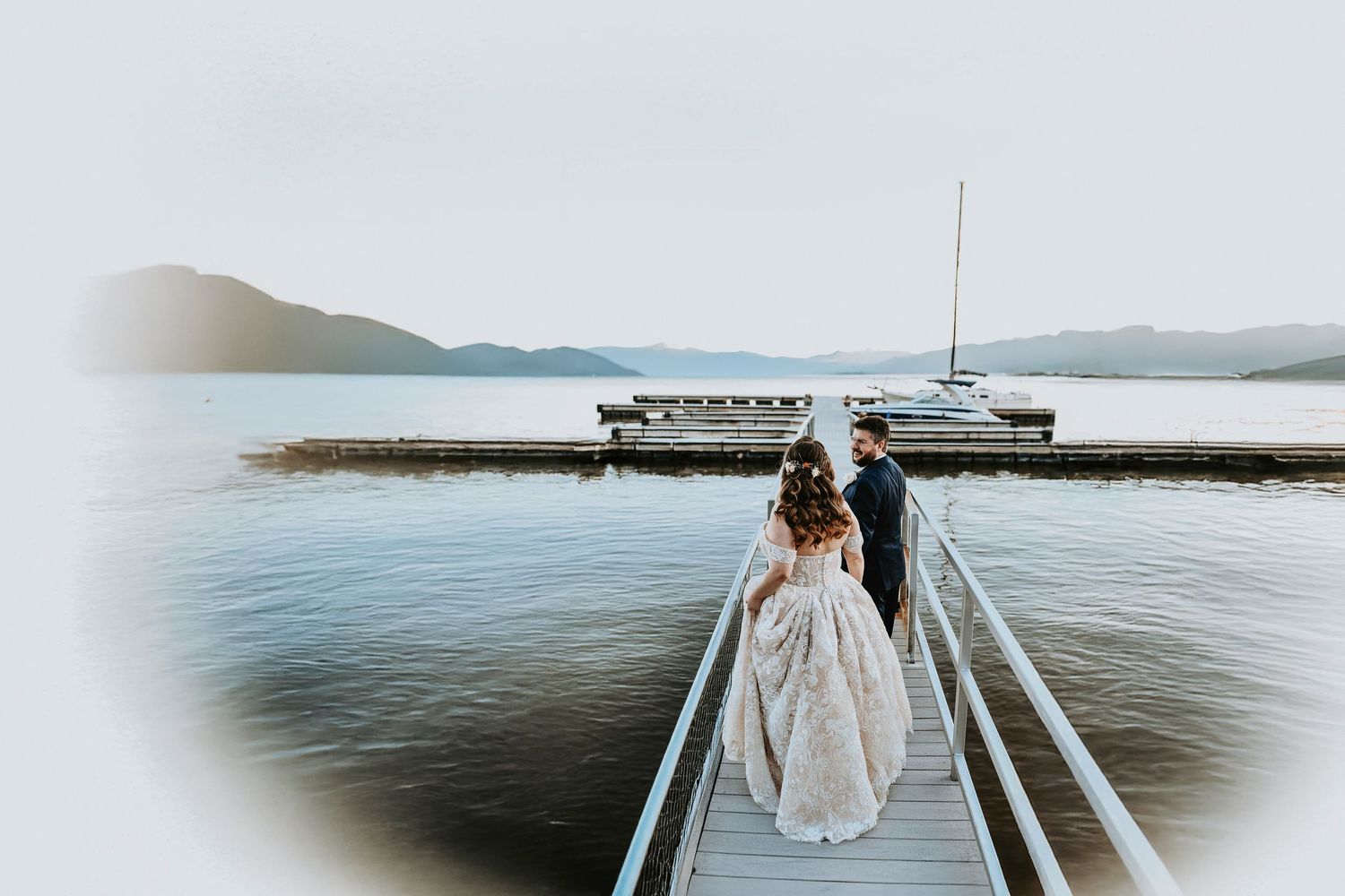 husband and wife walk towards the lake at possum kingdom after exchanging vows for their wedding day