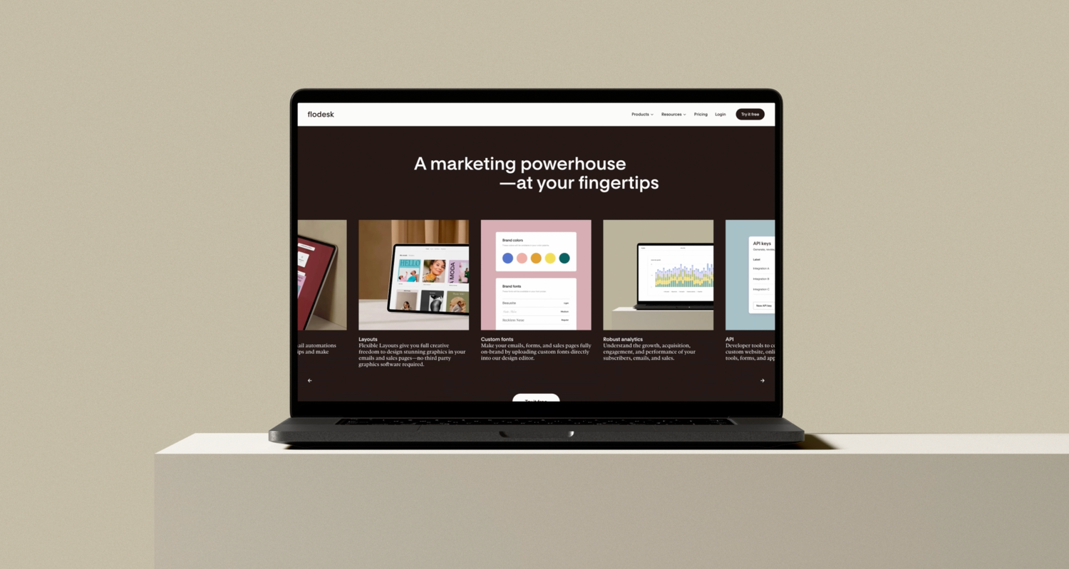 Laptop displaying a dark-themed marketing presentation website on white surface.