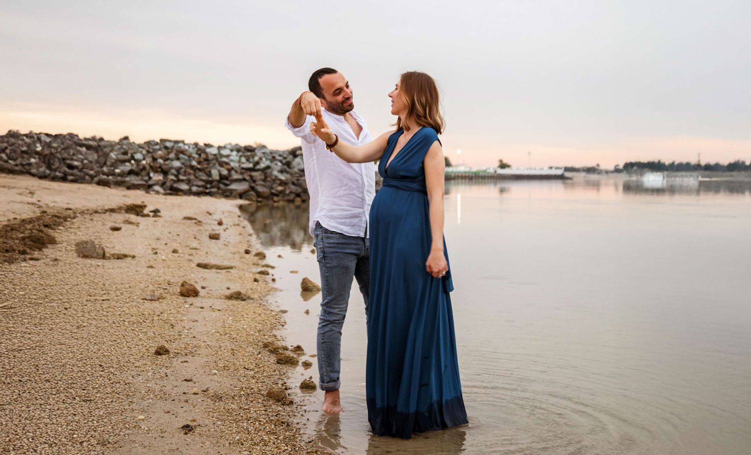beach maternity photoshoot blue dress dance in water abu dhabi uae