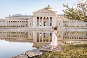 A series of architectural photos showing a grand white neoclassical building with columns and balustrades near a waterfront.