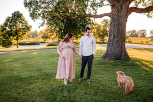Flowing maternity gown on a pregnant woman, captured during a sunset maternity session.