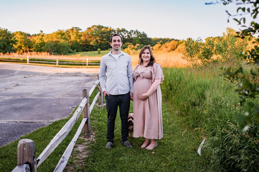 Flowing maternity gown on a pregnant woman, captured during a sunset maternity session.
