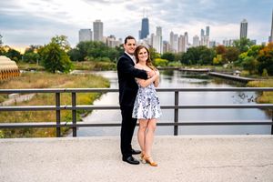 Couple enjoying a romantic moment together on a bridge overlooking the Chicago skyline and Lincoln Park.