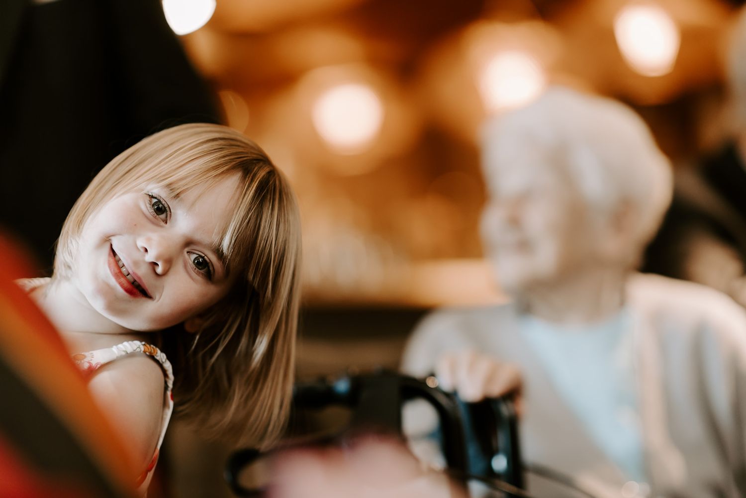 Person in dreamy warm lighting poses against blurred background for atmospheric portrait photography at a wedding