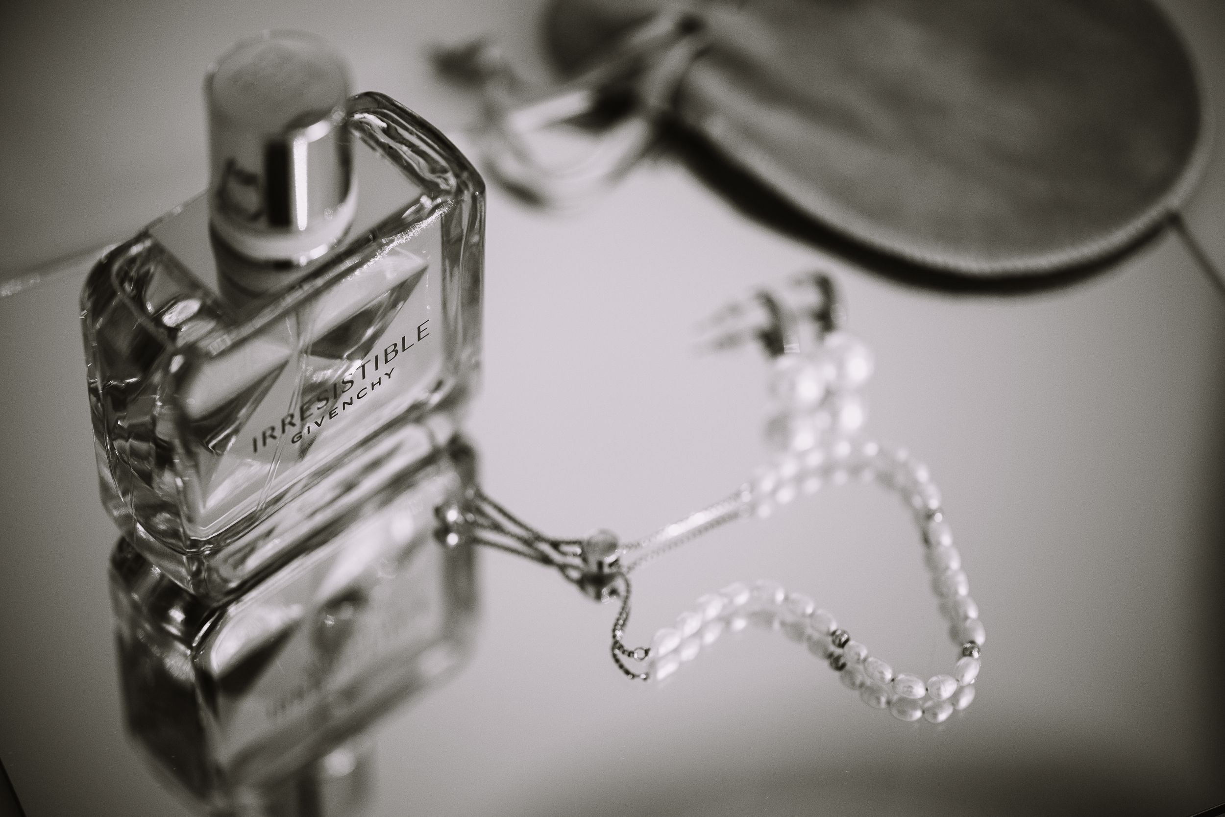 A close-up black and white photograph of water droplets dripping from a faucet or tap in a sequence.