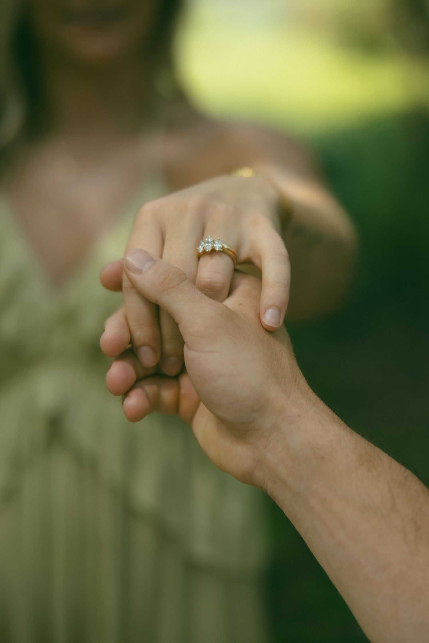 detail shot hand holding ring proposal engagement photoshoot