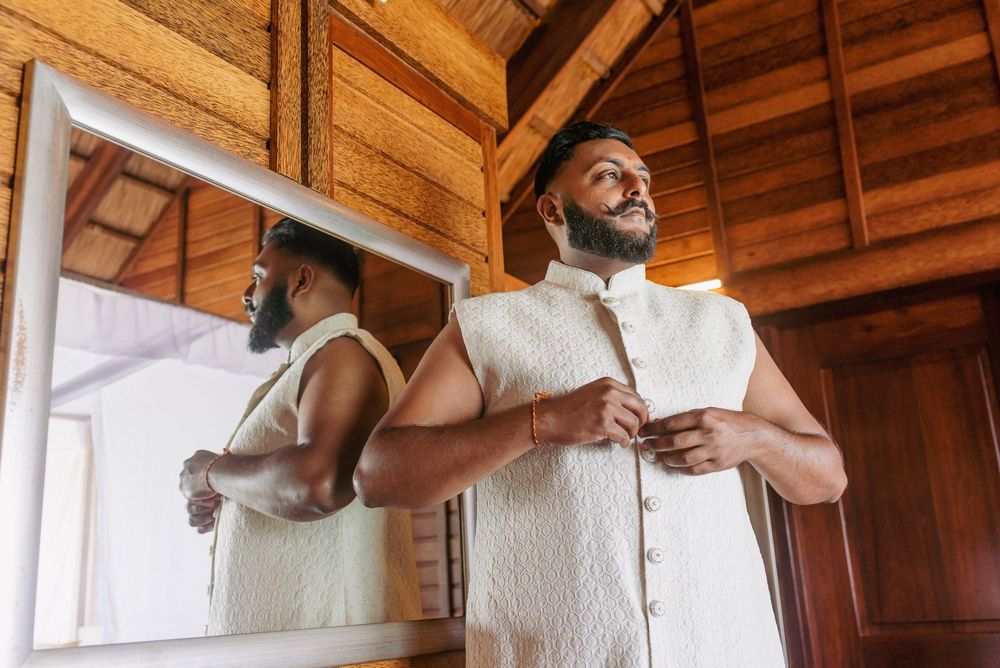 People sharing embraces and laughter in a wooden-paneled room.
