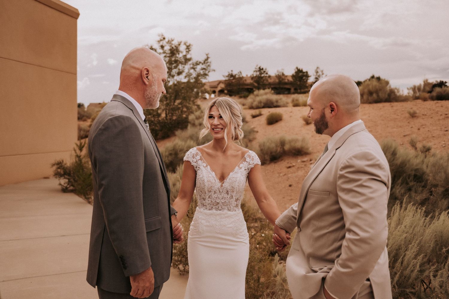 A wedding ceremony takes place outdoors in a desert landscape. Affordable wedding photographers in New Mexico. Queer wedding photographer NM