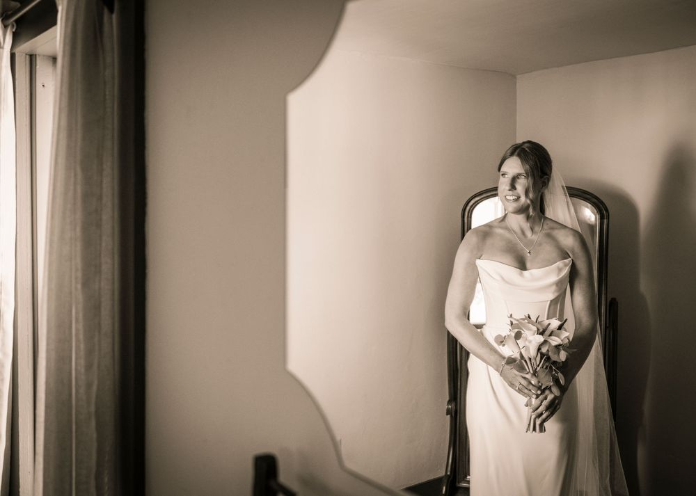A series of black and white wedding photographs showing bridal preparations with elegant details and soft lighting.
