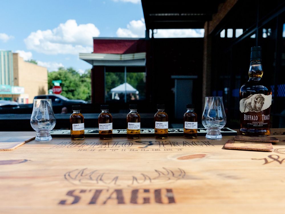 Elegant wine glasses lined up on a dark wooden surface at a fine dining restaurant.